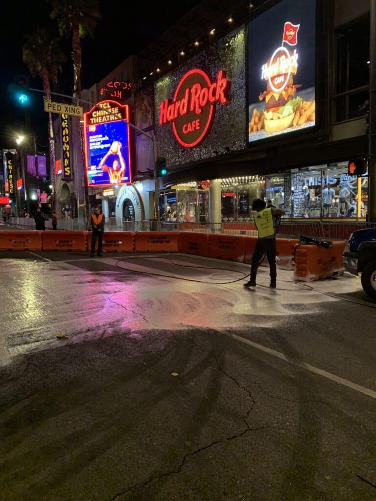 Our staff provides pressure washing services during nighttime on the streets of Hollywood in front of Hardrock Cafe.