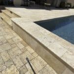 cleaning your pool view of concrete paving and sealing using pressure washing with Power Washing Pro